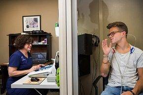 A teen undergoing hearing assessment with Dr. Liles